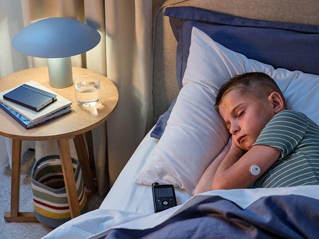 Boy sleeping and MiniMed 780G