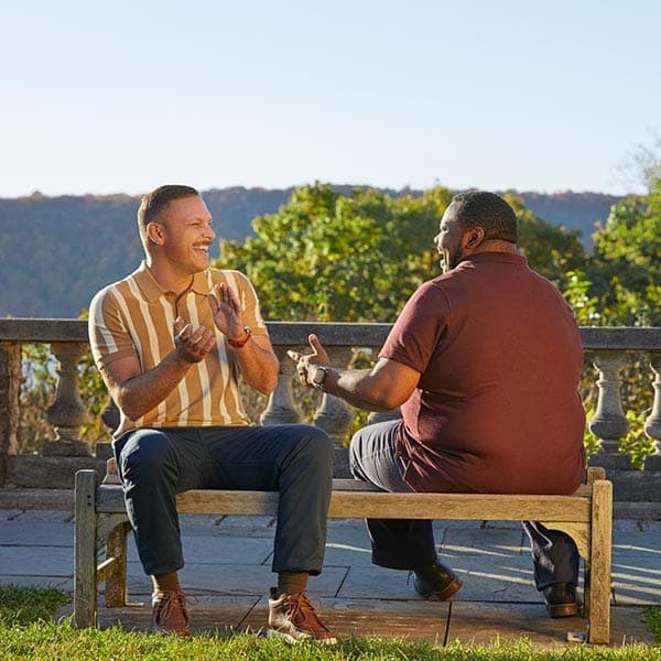 Two men on a bench laughing
